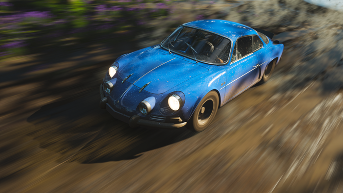 Blue Renault Alpine Rally Car on Dirt Road