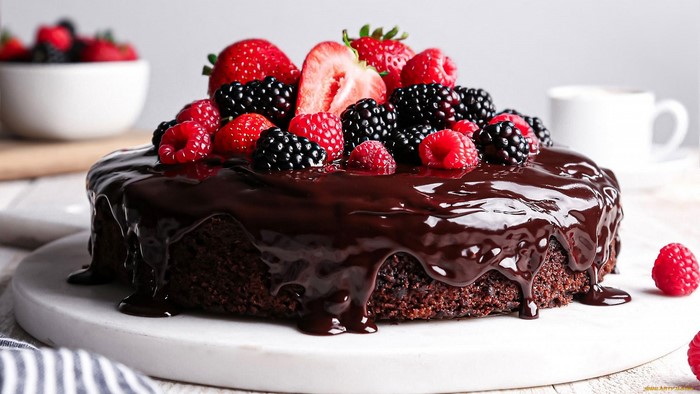 Chocolate cake with fresh berries and chocolate glaze