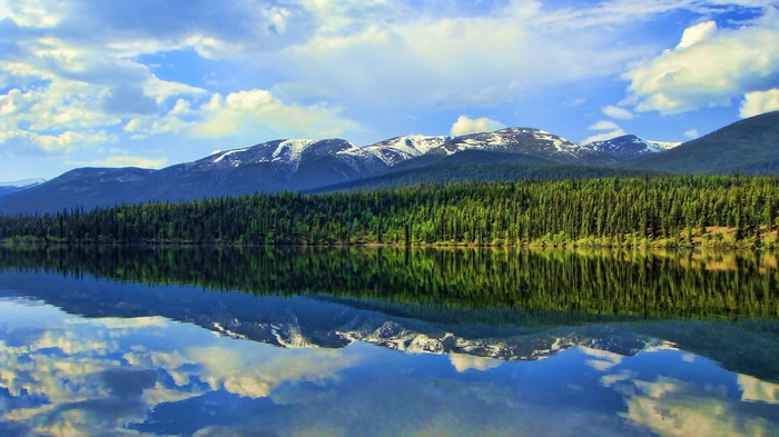 Snow-capped mountains reflected in a calm lake