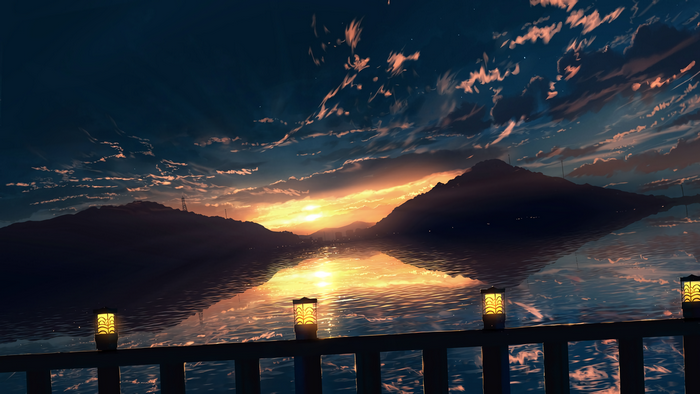 Sunset over water with hills and lanterns