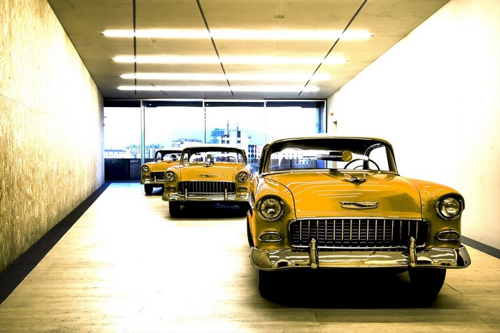 Three yellow Chevrolet Bel Air classic cars in a row