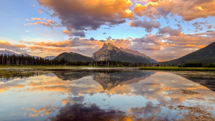 Mountain reflected in a calm lake at sunset