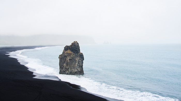 Black sand beach with rock formation in Iceland