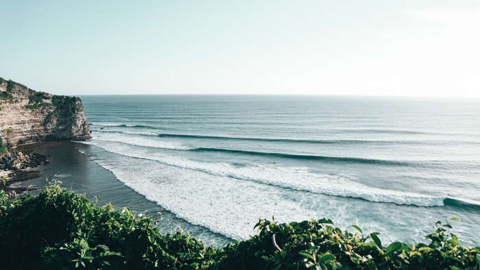 Waves crashing on a cliffside coast in Bali, Indonesia