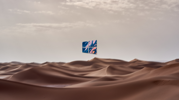 Windows 10 logo over desert dunes