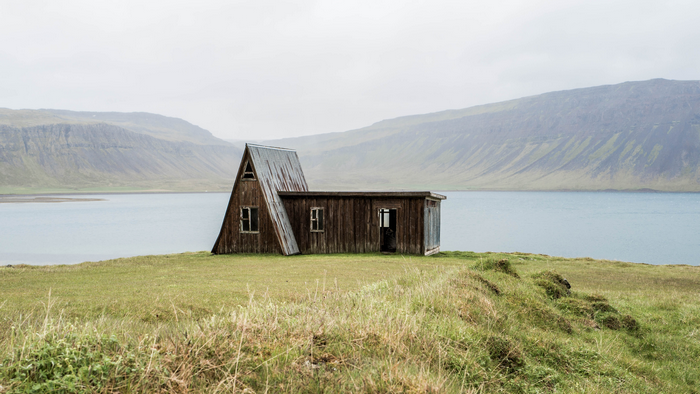 Abandoned wooden house by a fjord in Iceland
