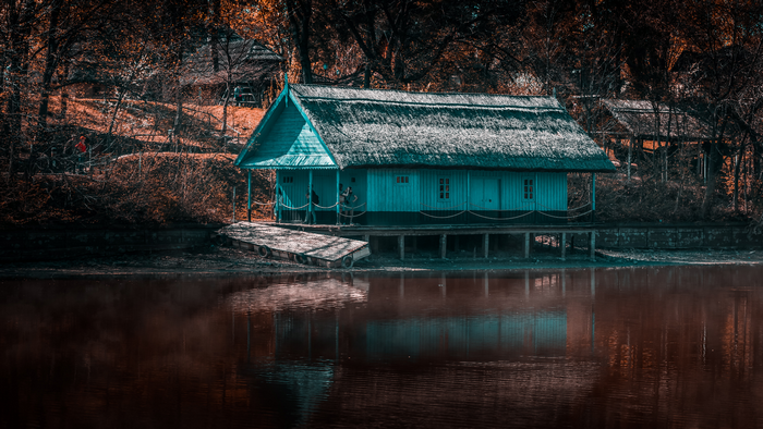 Blue wooden house on stilts by the water