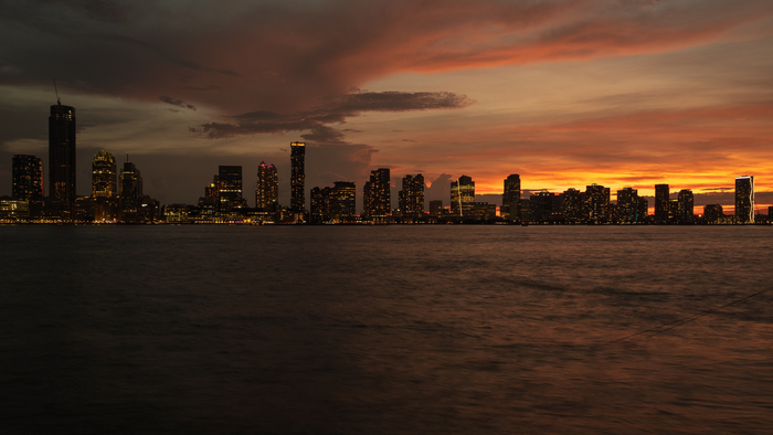 Cityscape skyline at sunset over water