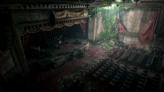 Abandoned theater stage with seats and debris