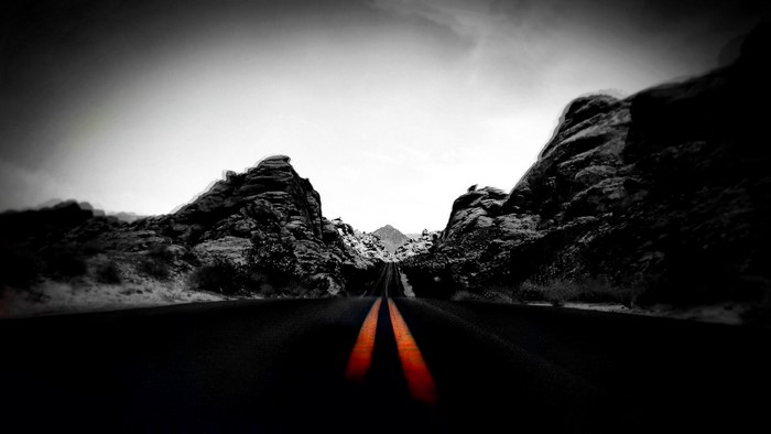 Road through rocky landscape with selective coloring