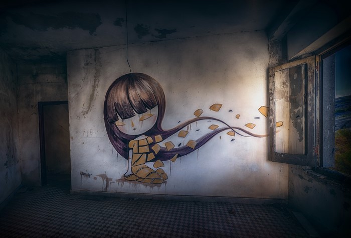 Graffiti of a girl in an abandoned room