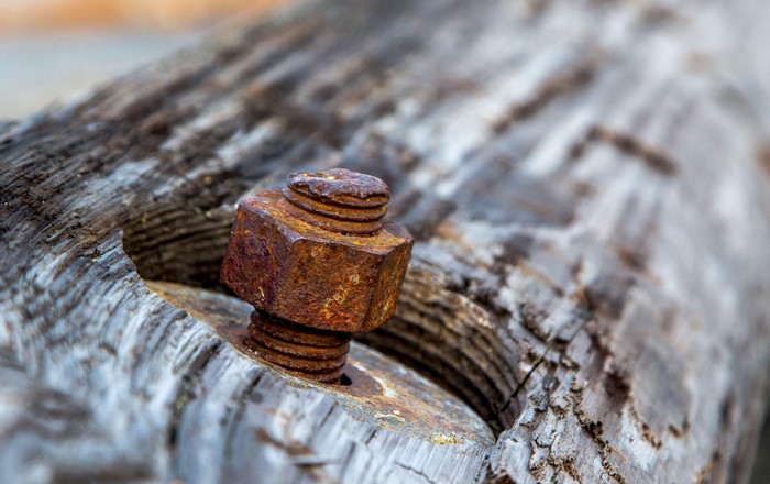 Rusty bolt and nut on weathered wood
