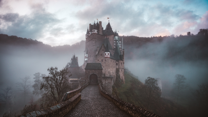 Eltz Castle in Germany shrouded in mist at dawn