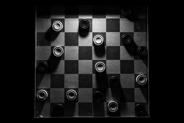 Checkerboard with black and white pieces