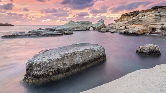 Sea caves and rock formations at sunset in Cyprus