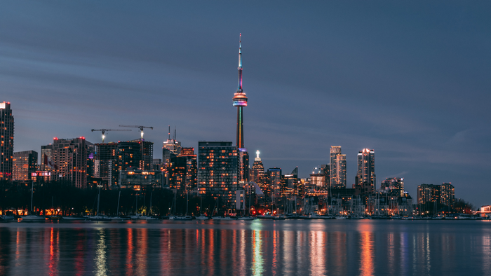 Toronto skyline with CN Tower at night over water