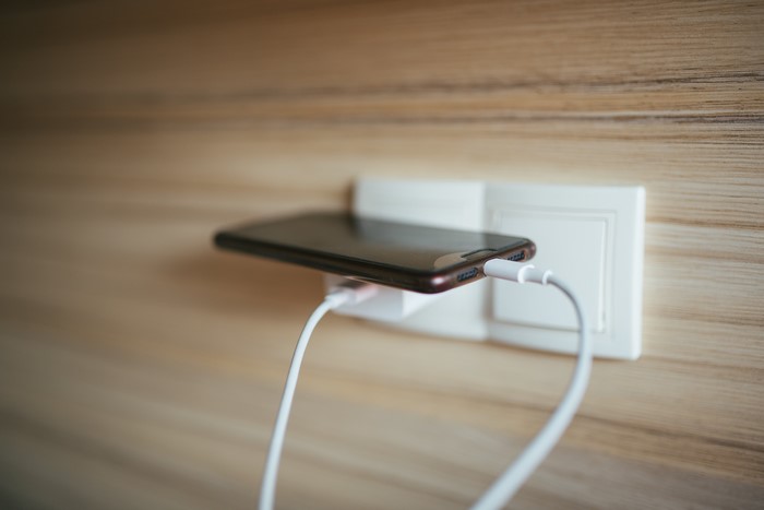 Smartphone charging in wall outlet