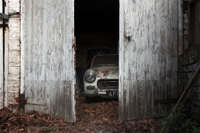 Old car in a dilapidated garage