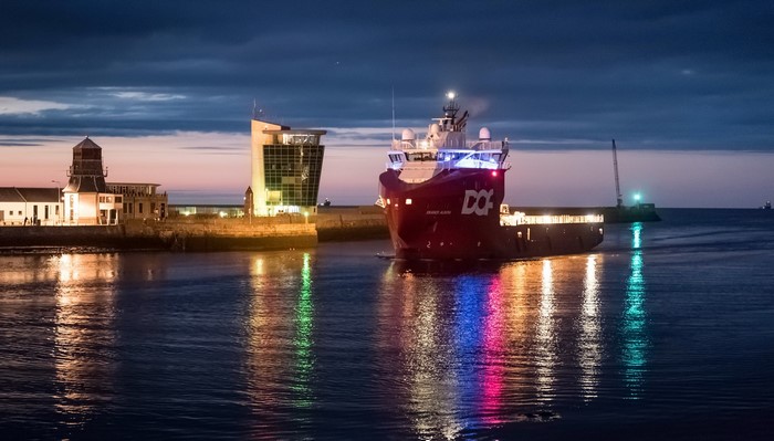 Ship leaving Aberdeen harbor at dusk