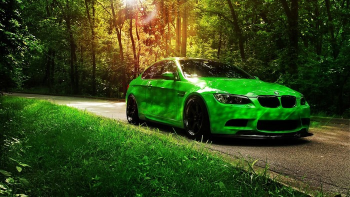 Green BMW M3 on a forest road