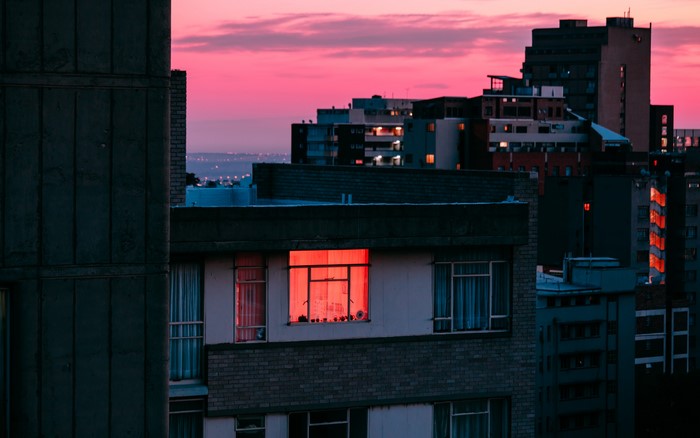City skyline at dusk with illuminated windows