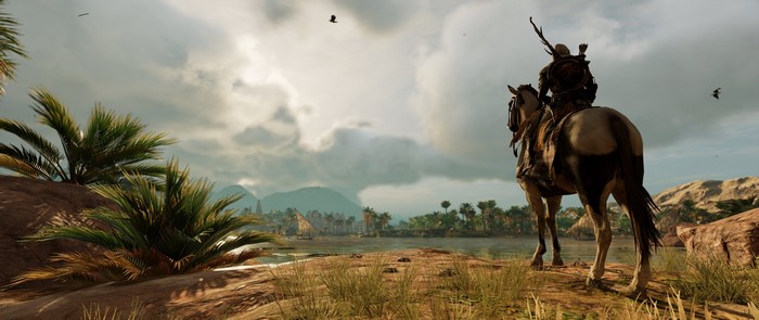 Assassin's Creed Origins: Bayek on horseback overlooking a village
