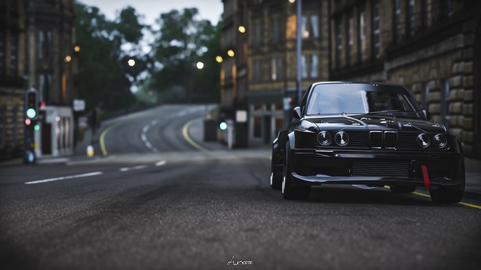Black BMW E30 M3 on a city street