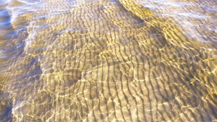 4K water and sand ripples at the beach