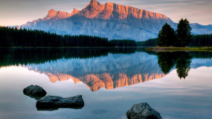 Mountain reflected in a calm lake at sunrise