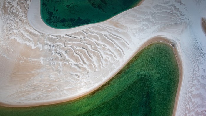 Aerial view of sand dunes and clear water in Brazil