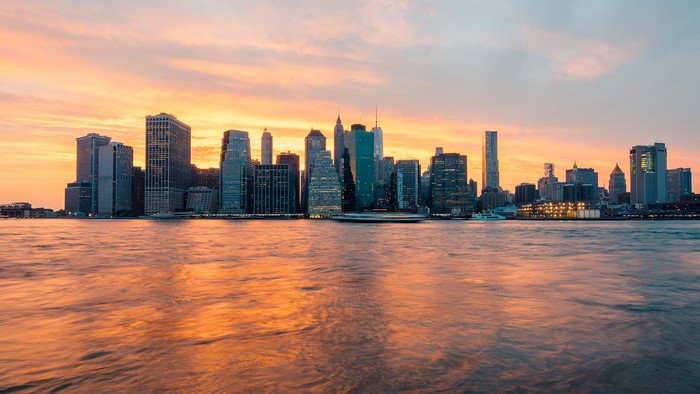 New York City skyline at sunset over the water