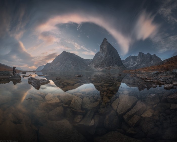 Mountain lake reflection with photographer, Yukon
