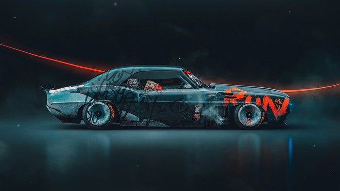 Graffiti-covered vintage car with orange accents