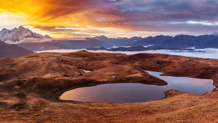 Sunset over Caucasus Mountains in Georgia with ponds