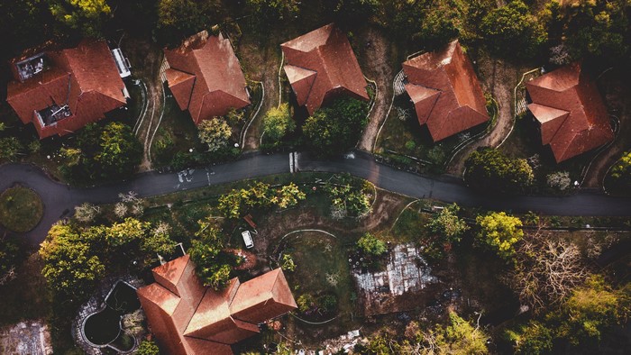 Aerial drone photo of abandoned houses with red roofs