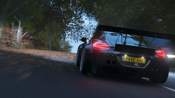 Porsche Cayman GT4 racing on a road
