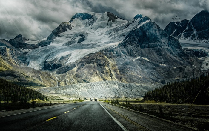 Road leading to a vast glacier and mountains