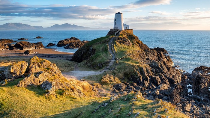 Lighthouse on a rocky coast in Wales, UK