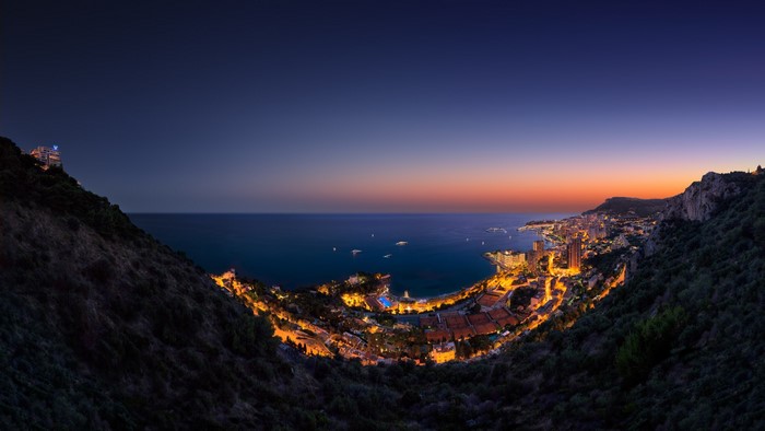 Monaco cityscape at sunset from hills overlooking the sea