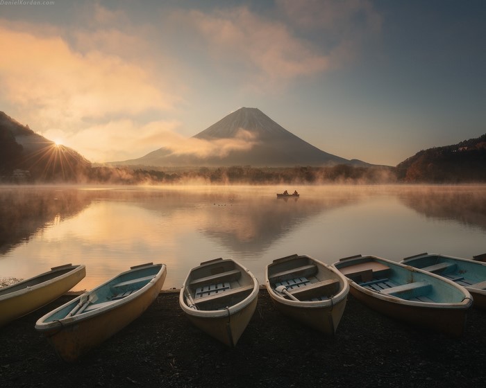 Sunrise over Mount Fuji with boats on Lake Shojiko