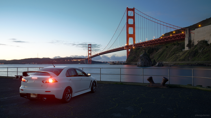 White Mitsubishi Lancer Evolution X by Golden Gate Bridge