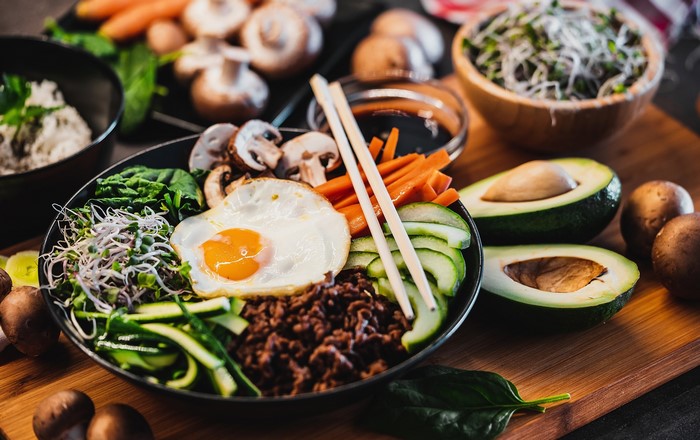 Bibimbap with fried egg, vegetables, and mushrooms