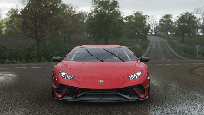 Red Lamborghini Huracan Performante on a wet road