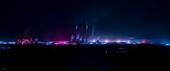 Factory at night with pink and blue lights