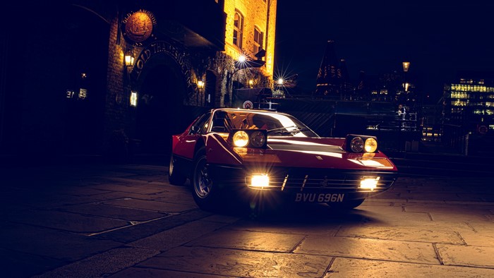 Red Ferrari 365 GT/4 BB with pop-up headlights at night