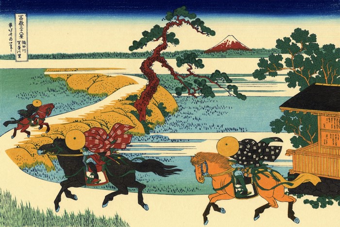 Travelers on a road with Mount Fuji in the background