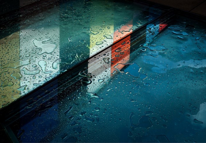 Water droplets on glass with colorful reflections