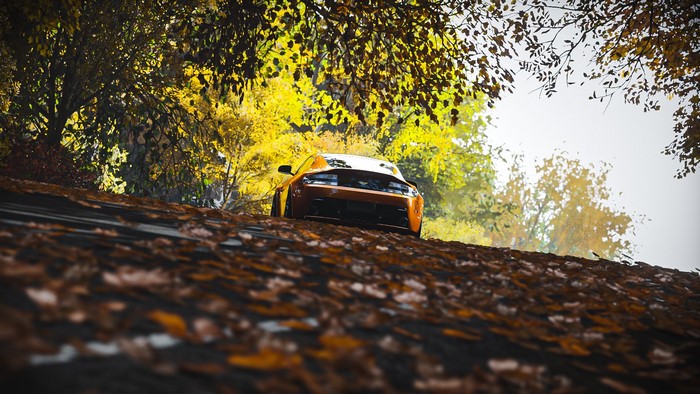 Orange Aston Martin Vantage S in Autumn Forest