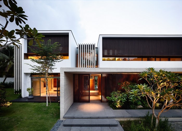 Modern house with wooden accents and lush landscaping