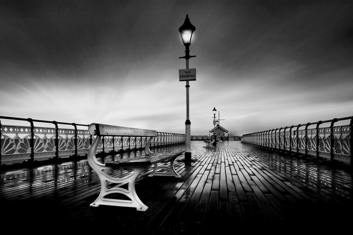 Monochrome pier with bench and street light